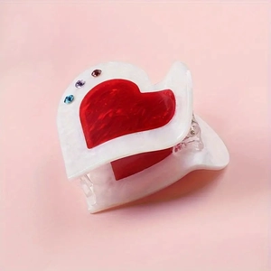 Detailed view of red and white heart acrylic hair claw with sparkling rhinestones decoration