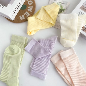 Flat lay of five pairs of colorful ribbed cotton socks for kids in candy tones