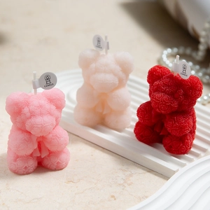Rose-patterned bear scented candles in pink, cream, and red for home decor