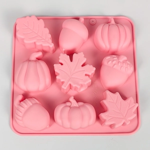 Pink silicone mold with 9 compartments featuring pumpkin, maple leaf and acorn shapes