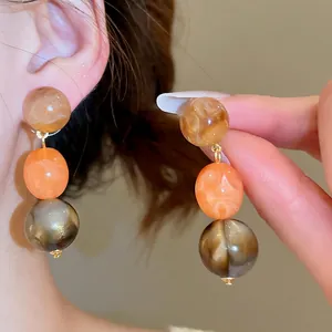 Retro acrylic geometric earrings with amber marble beads and golden metal rings