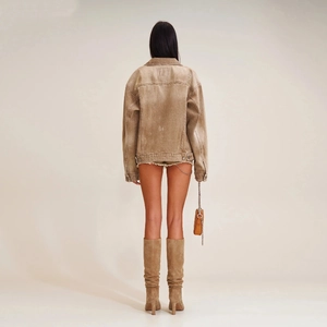 Detailed back view of an oversized khaki denim jacket with vintage distressed textures