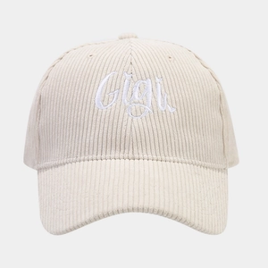 Detailed view of Gigi embroidery on cream corduroy texture of the fashion baseball cap