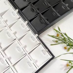 Detail of black and white 24-slot jewelry display trays for necklaces and pendants