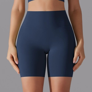 Detail of high waisted navy blue seamless yoga shorts with tummy control on model