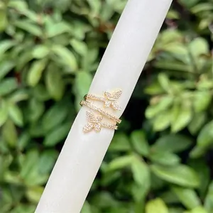 18K gold plated butterfly wrap ring featuring pave cubic zirconia on a white stand