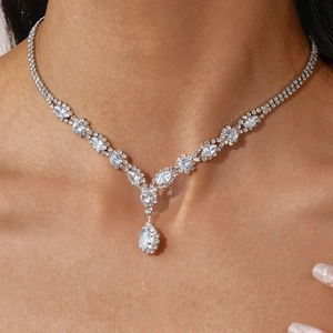 Macro shot of silver zircon droplet necklace featuring marquise cut stones and V-shape pendant