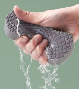 Detailed shot of grey 3D bath sponge showing water absorption and fish scale texture