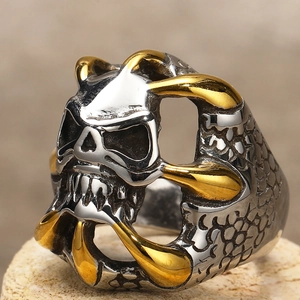 Macro shot of vintage skull ring with gold claw details and dragon scale texture on stone