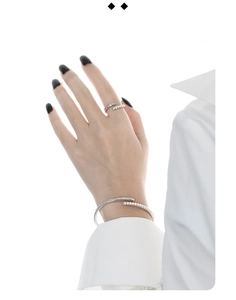Detailed view of silver S925 ring and bracelet set with square diamonds and pearls