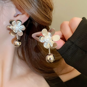 Metallic flower petal stud earrings with white pearl and hanging silver sphere on model