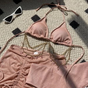 Detail of pink glitter bikini with gold chain link and crystal water drop charms