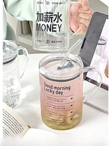 Detail of high borosilicate glass mug with time marker and creative print on office desk