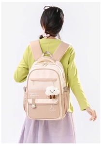 Detail of waterproof beige school backpack with cloud pendant and floral pattern text