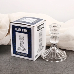 Elegant vertical striped glass candle holder with premium packaging on a textured surface
