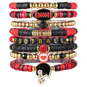 Detail showing 8-piece football mom bracelet set with heishi beads and sport charms