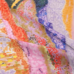 Detailed macro view of lightweight sheer fabric with vibrant sunset abstract pattern