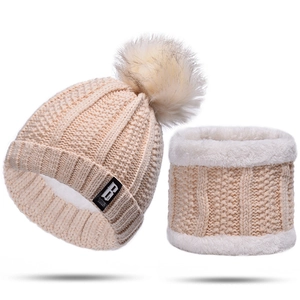 Detail view of the chunky knit beanie and neck warmer set with thick plush lining and fur pom