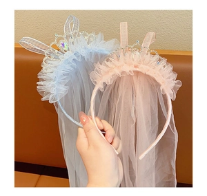 Detail of pink and blue princess crown headbands with tulle ruffles and shiny rhinestones