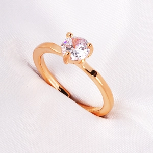Vintage gold plated emerald zircon ring with heart and oval cut stones on silk background