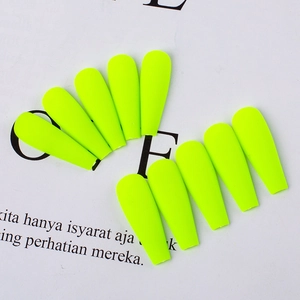 Detailed view of neon green matte coffin press on nails in symmetrical layout