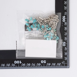 Detail view of bohemian necklace with turquoise stones and silver paperclip chain link
