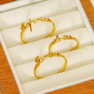 Customized gold stainless steel zodiac name rings in a premium velvet jewelry box display