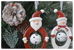 Detail of resin Santa and Snowman ring ornaments with white star hollow bells