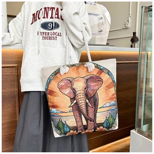 Detail of colorful elephant embroidery on a large canvas tote bag with thick cotton ropes