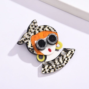 Detailed view of handmade acetate brooch featuring a retro girl with headscarf and sunglasses