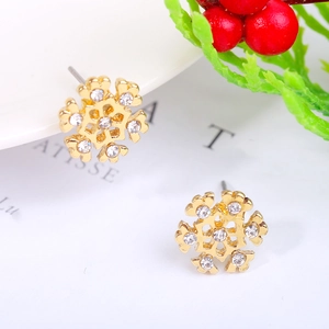 Close-up of golden snowflake stud earrings with sparkling crystals for Christmas