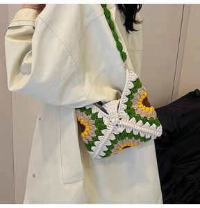Model wearing a handmade crochet sunflower shoulder bag with floral knit patterns