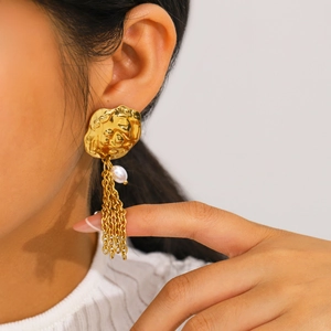 Oversized gold petal earrings with faux pearl tassels on model, elegant statement jewelry