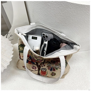 Spacious interior of ethnic canvas tote bag with owl print and secure zipper closure