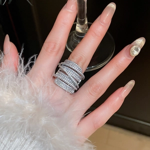 Macro shot of silver-plated multi-layer ring with sparkling cubic zirconia on finger