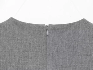 Detail shot of the back neckline featuring a hidden zipper on a gray satin dress