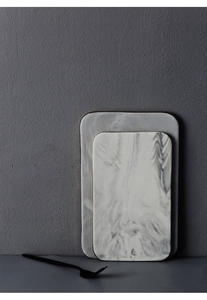 Detail of rectangular marble texture ceramic tray with elegant gold trim and black fork