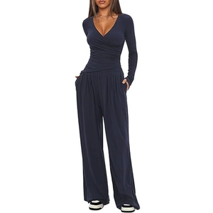 Front view of navy blue long sleeve V-neck wide leg jumpsuit with cinched waist design