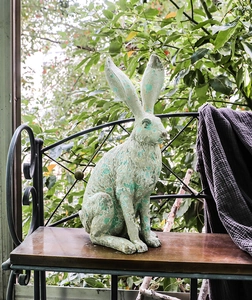 Detailed view of long-eared rabbit sculpture with vintage mint green distressed finish