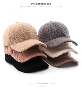 Pile of colorful plush fleece baseball caps showing thick faux shearling texture in detail