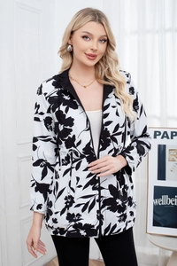 Detail of hooded zip jacket featuring black and white floral patterns and drawstring waist