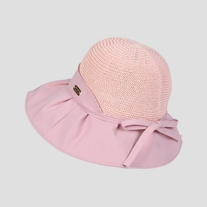 Detail of summer sun hat featuring breathable knit top, pink bow, and metallic logo plate