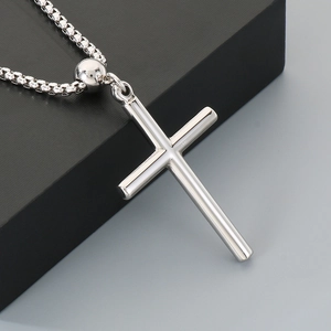 Detailed view of silver stainless steel cross pendant on a classic square box chain