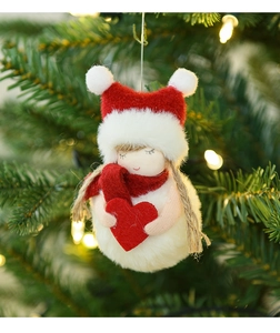 Detail of red and white plush snowman hanging on Christmas tree with warm lights