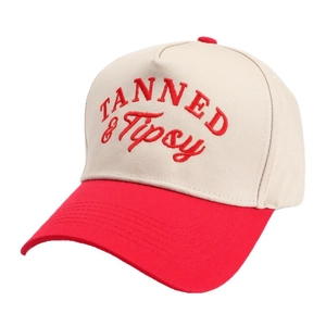 Beige and red trucker hat with TANNED & Tipsy embroidery on a white background