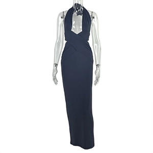 Close-up of the elegant halter neckline and crisscross waist pleats on navy maxi dress