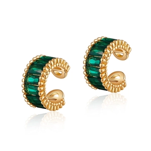 Close-up of C-shaped ear cuffs with emerald green zircons and 18K gold plated finish