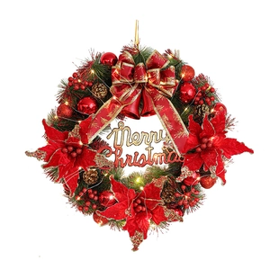Illuminated Christmas wreath with Merry Christmas sign, red flowers and LED lights