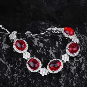 Luxury oval ruby red gemstone bracelet with micro-paved white zircon in silver setting