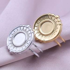 Macro shot of gold and silver sunburst rings with bead details on silk background